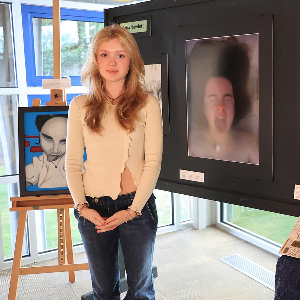 Sofia in front of some of her artwork