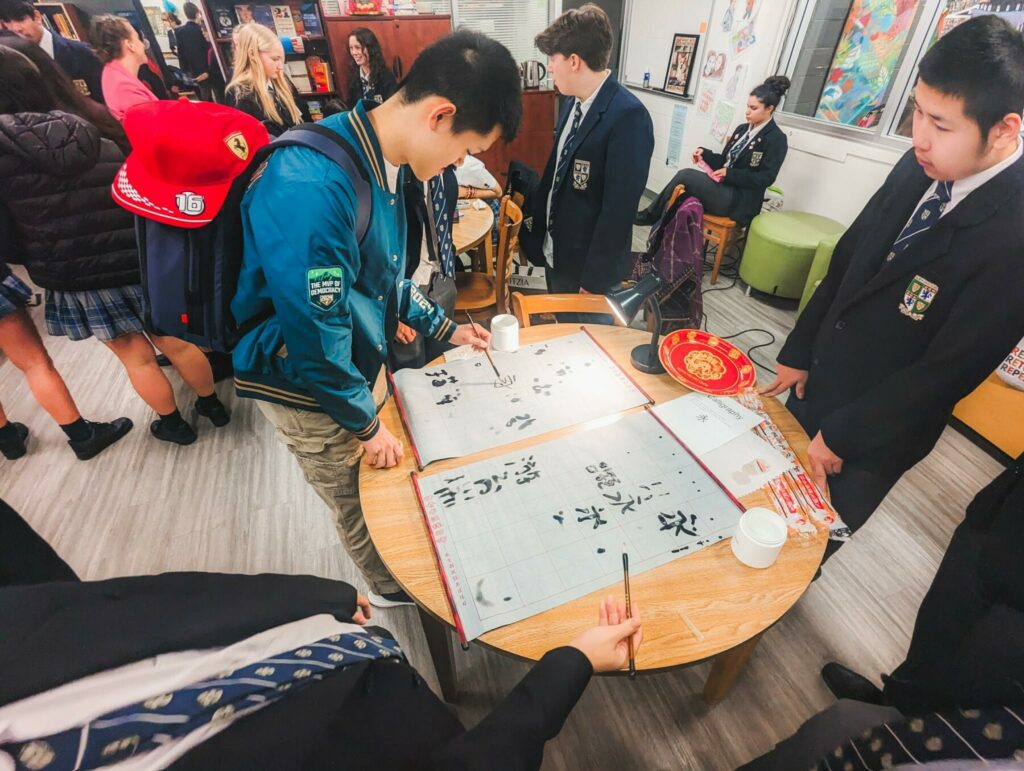 Students giving calligraphy a try.