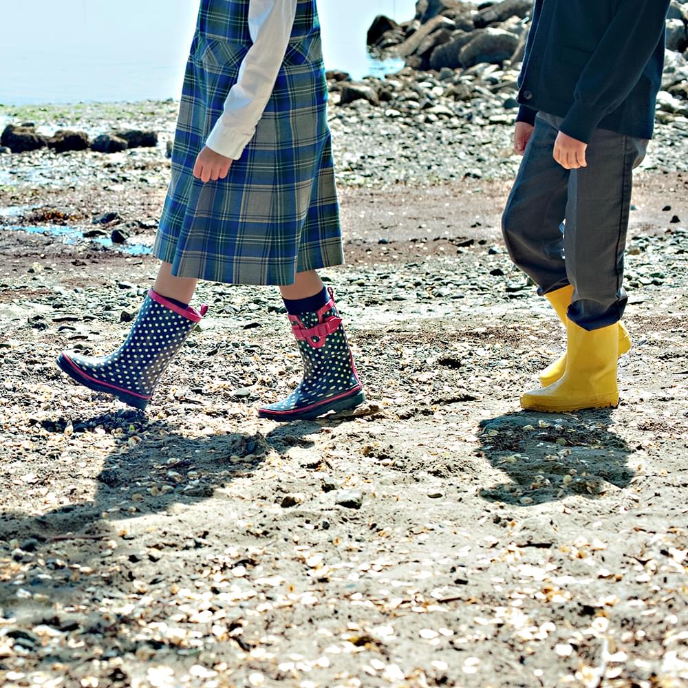 Junior School students in boots on beach