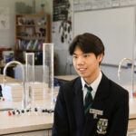 GNS student sits in chemistry classroom