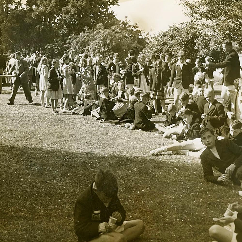 Students eating ice cream at 1950 sports day