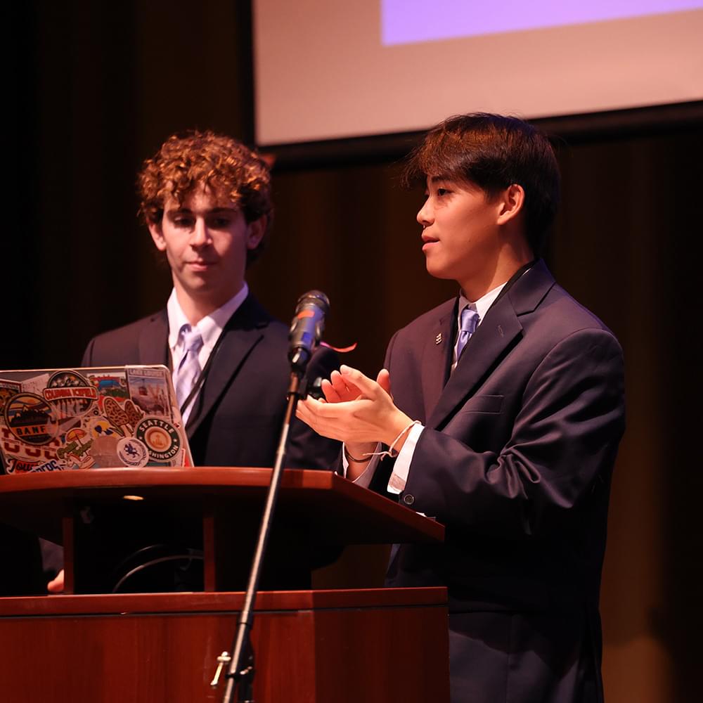 Student presenting at podium