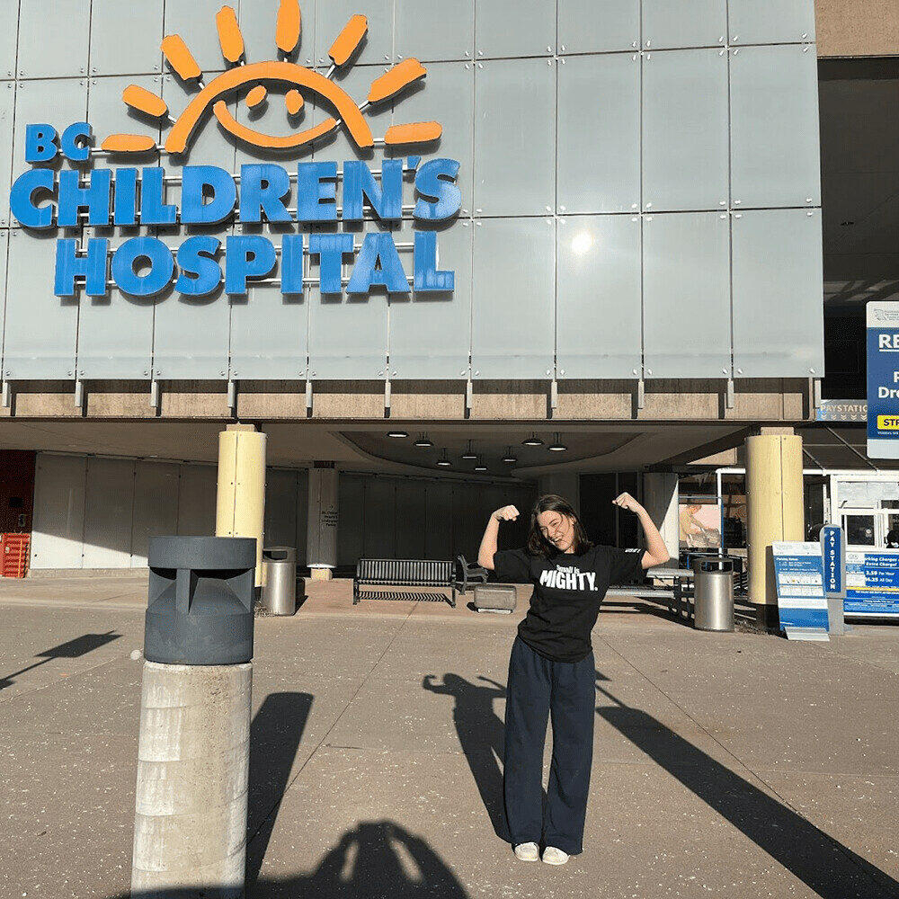 Student pictured outside BC Children's Hospital, wearing Be the Mighty shirt