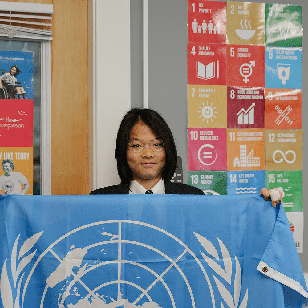 student with UN flag