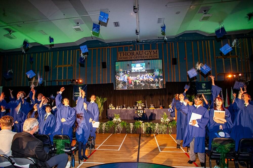 graduating students throwing caps at end of ceremony