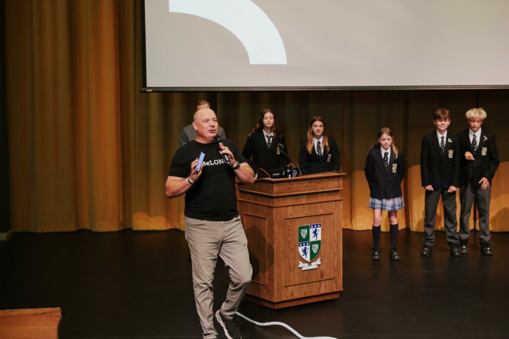 Jeff Gerber speaks to students about individuality and community on stage at GNS.