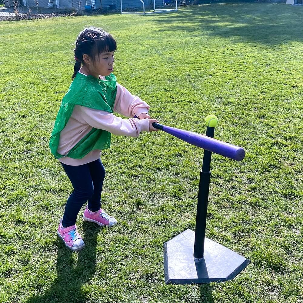 a child playing t-ball at a spring break camp
