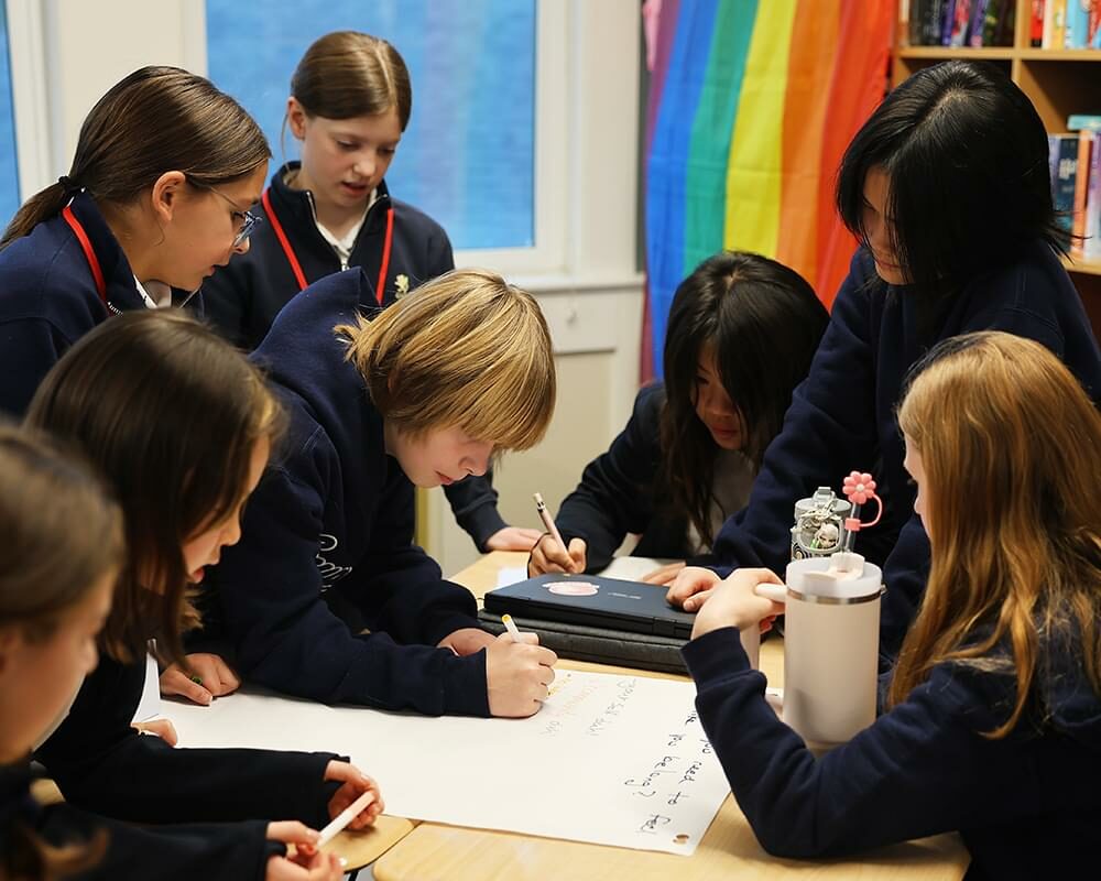 Middle School students working together collaborating on a project