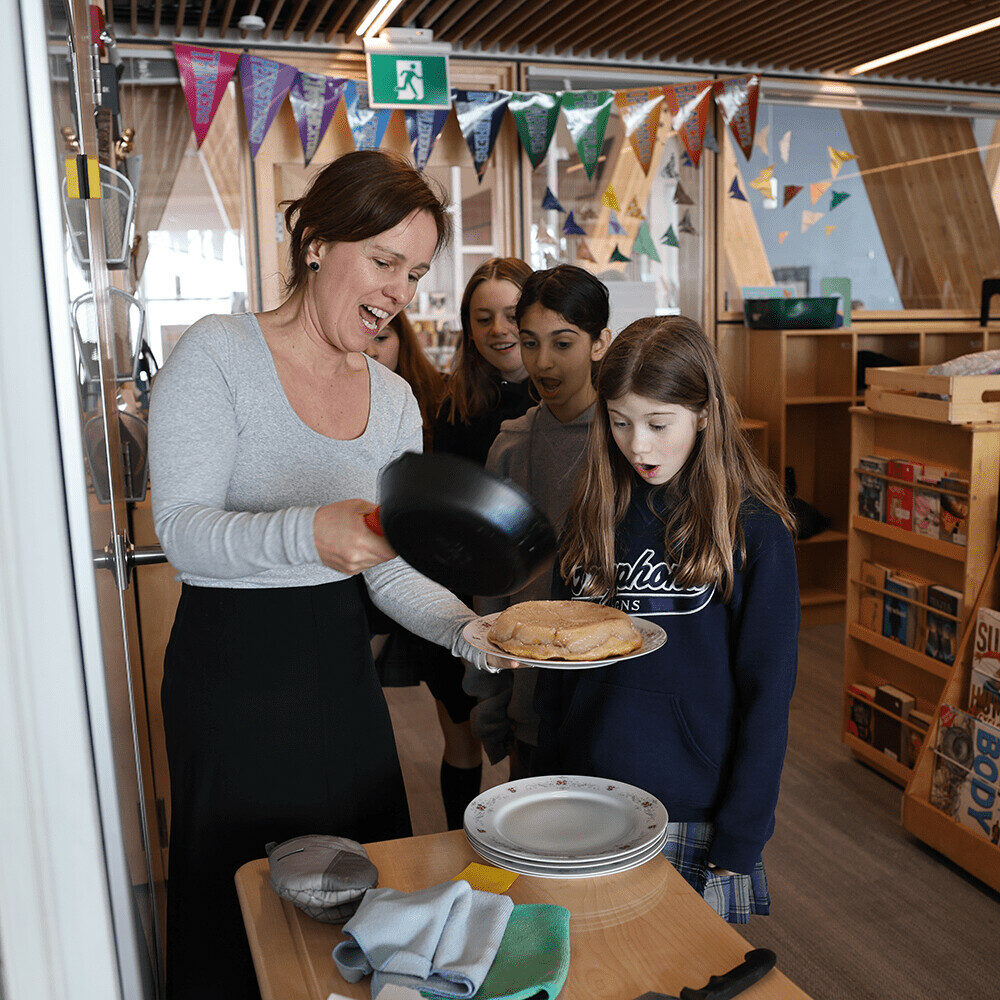 GNS teacher with students baking