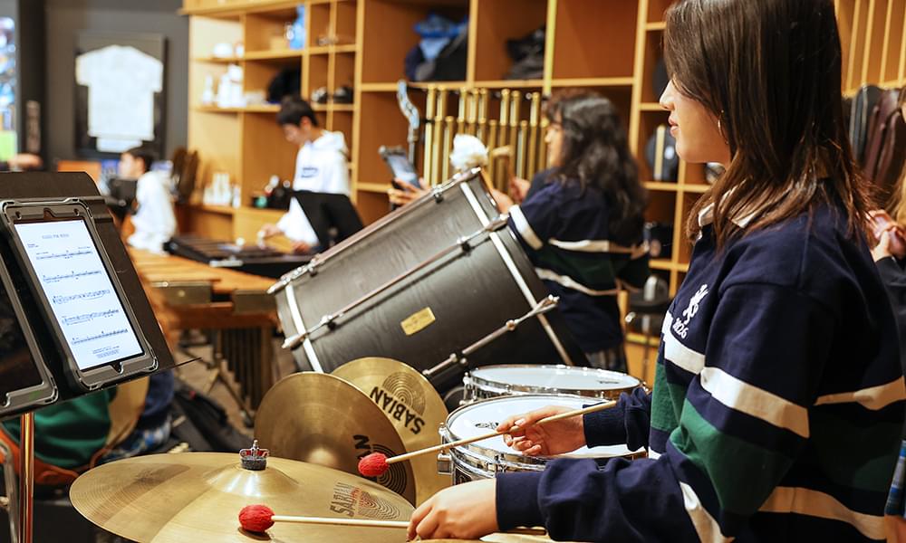 Student playing drums using and iPad