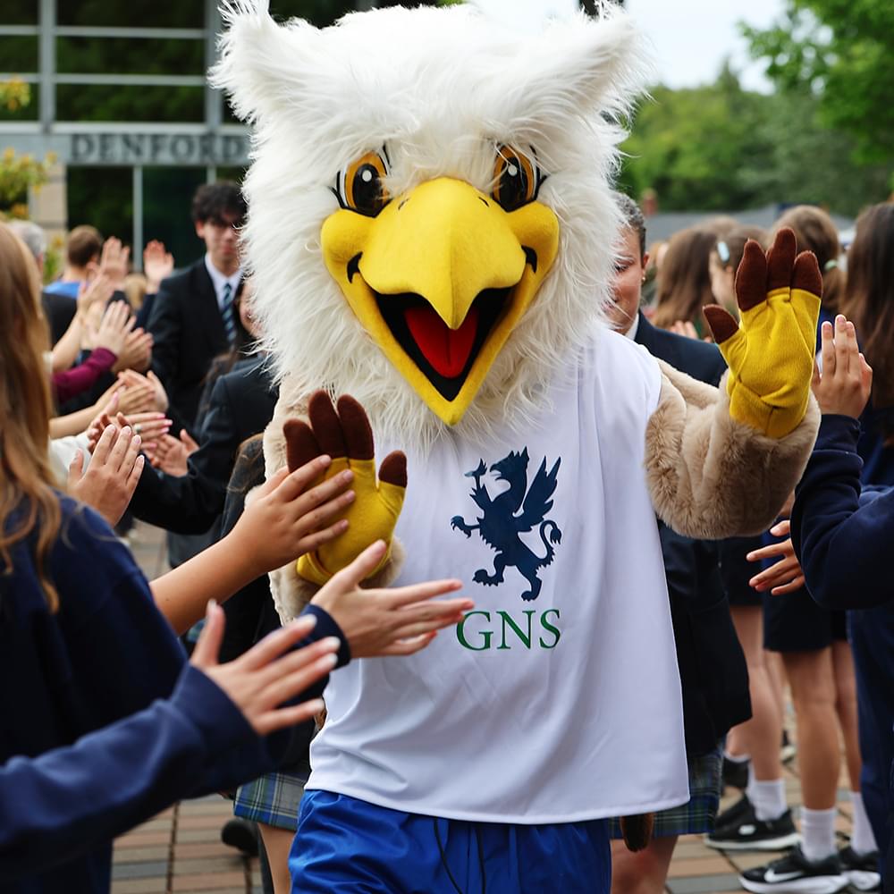 The Gryphon mascot with students