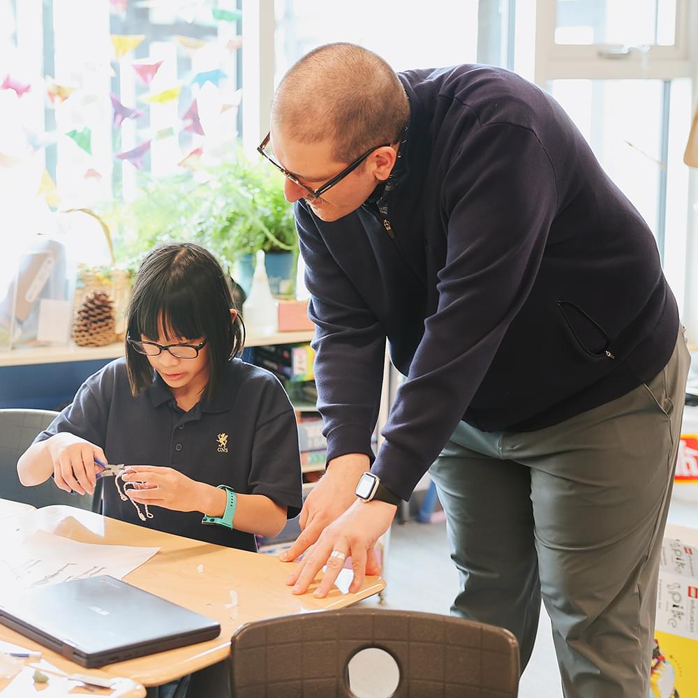 A teacher helping a student at Glenlyon Norfolk School in Victoria BC