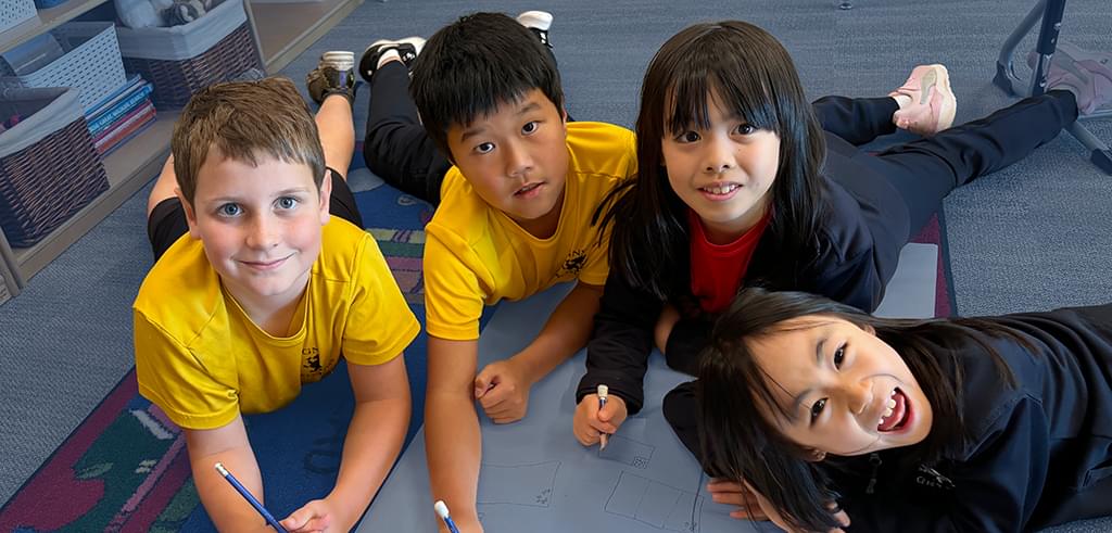 Junior School students smiling at the camera